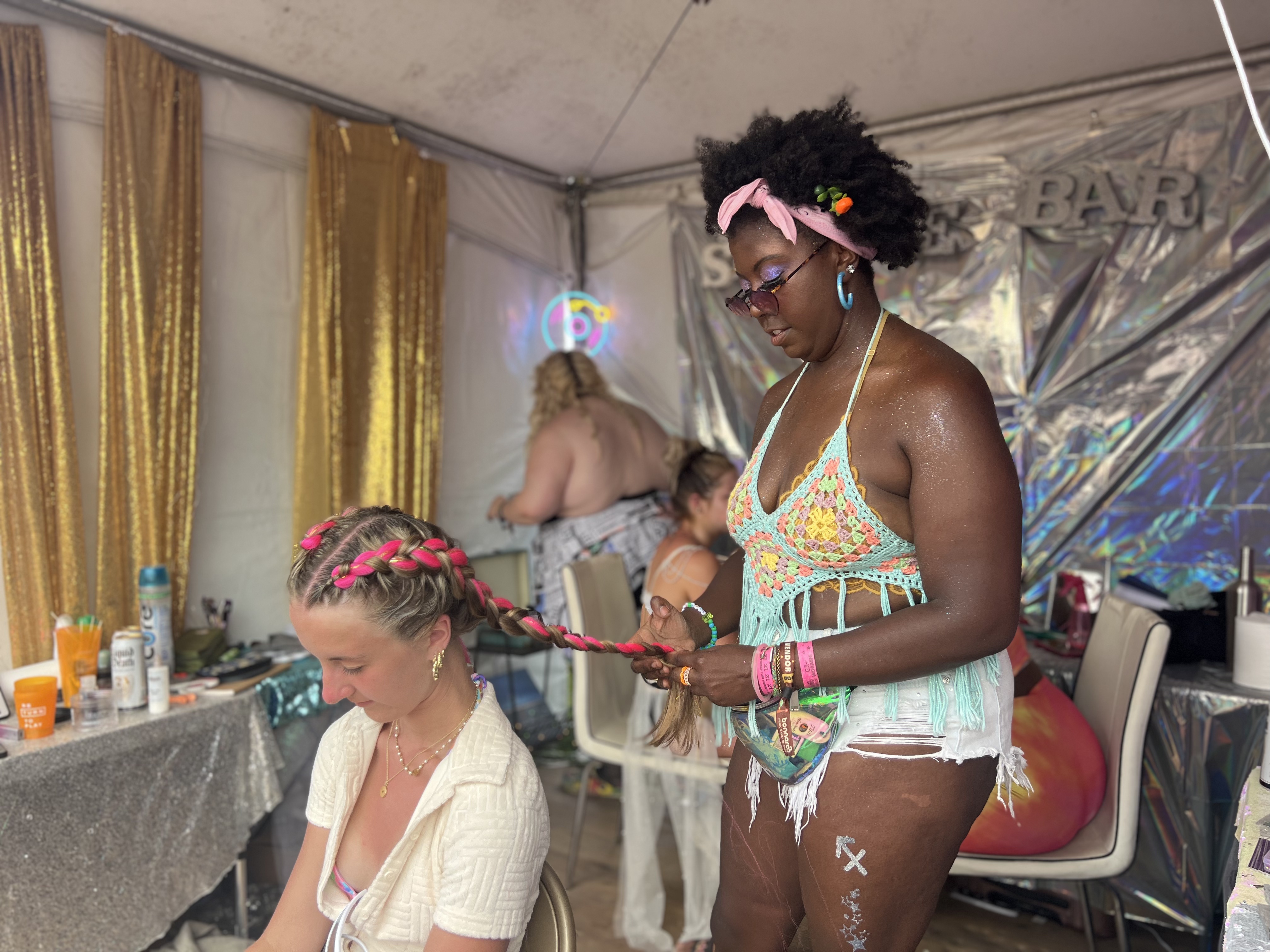 woman braiding a clients hair